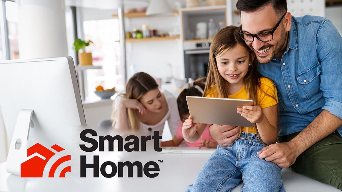 family with devices on couch