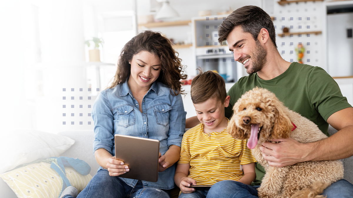 Happy family with modern devices and dog having fun, playing at home