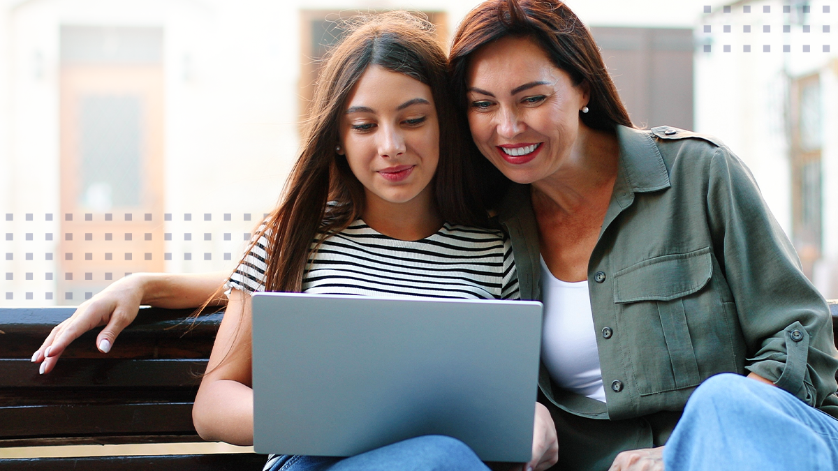 A mother and daughter viewing a laptop connected with community Wi-Fi