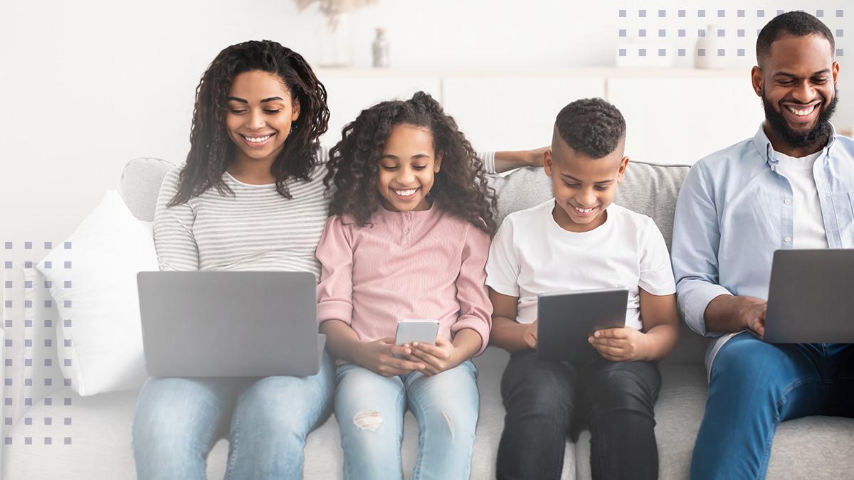 Happy african american family holding and using gadgets