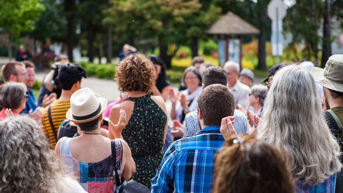 people applauding outdoors in park